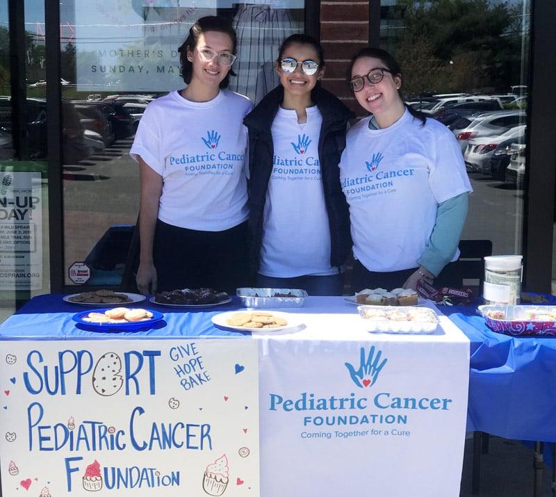 Volunteers behind the PCF Give Hope Bake table in May 2019.